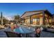 Stunning backyard with covered patio, rock waterfall, and desert-inspired landscaping at 15123 E Monument Rd, Scottsdale, AZ 85262