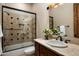 Bathroom features tub-shower combo, vanity with a travertine countertop, and a framed mirror at 15123 E Monument Rd, Scottsdale, AZ 85262