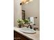 Bathroom vanity boasts a travertine countertop, vessel sink, and oil rubbed bronze fixtures at 15123 E Monument Rd, Scottsdale, AZ 85262