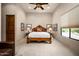 Comfortable bedroom with carpet floors, decorative bed frame, and a large window at 15123 E Monument Rd, Scottsdale, AZ 85262