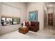 Cozy bedroom with leather seating, desert views, and a large decorative art piece at 15123 E Monument Rd, Scottsdale, AZ 85262