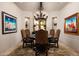 Formal dining room with chandelier, decorative rug, and seating for six at 15123 E Monument Rd, Scottsdale, AZ 85262