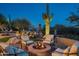 Cozy backyard fire pit area with comfortable seating and desert landscape at 15123 E Monument Rd, Scottsdale, AZ 85262