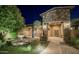 Stunning home entrance featuring stone accents and a beautifully landscaped yard at 15123 E Monument Rd, Scottsdale, AZ 85262