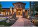 Stunning entryway with stone facade, desert landscaping and walkway leads to custom front door at 15123 E Monument Rd, Scottsdale, AZ 85262