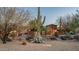 Beautifully landscaped desert home with mature trees and an inviting walkway at 15123 E Monument Rd, Scottsdale, AZ 85262