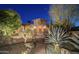 Beautiful desert landscaping surrounds this home with mature trees and gated entry in Scottsdale, Arizona at 15123 E Monument Rd, Scottsdale, AZ 85262