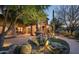 Inviting front yard with a desert landscape and a stone water fountain at 15123 E Monument Rd, Scottsdale, AZ 85262