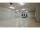 Well-lit garage featuring plenty of storage cabinets and epoxy flooring at 15123 E Monument Rd, Scottsdale, AZ 85262