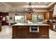 Kitchen island with granite countertop, stainless steel microwave, and seating at 15123 E Monument Rd, Scottsdale, AZ 85262