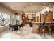 Spacious kitchen with breakfast bar, center island, and view of the breakfast table and desert landscape at 15123 E Monument Rd, Scottsdale, AZ 85262