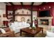 Living room features built-in shelving, recessed lighting, a stone fireplace, and comfortable seating at 15123 E Monument Rd, Scottsdale, AZ 85262