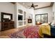Open living room with fireplace, media center, hardwood floors and large area rug at 15123 E Monument Rd, Scottsdale, AZ 85262