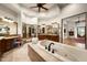 Large main bathroom featuring soaking tub, wood cabinets, dual vanities and natural light at 15123 E Monument Rd, Scottsdale, AZ 85262