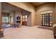 Covered patio with fireplace, tile flooring, a seating area and an entrance to the home at 15123 E Monument Rd, Scottsdale, AZ 85262