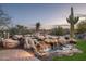 Beautiful rock waterfall feature adds a touch of nature to the lush backyard at 15123 E Monument Rd, Scottsdale, AZ 85262