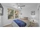 Bright bedroom with ceiling fan, light wood floors and two windows at 15221 N Clubgate Dr # 2094, Scottsdale, AZ 85254