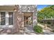 Inviting entrance with a modern door, textured walls, and manicured greenery at 15221 N Clubgate Dr # 2094, Scottsdale, AZ 85254