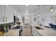 Well-lit kitchen with stainless steel appliances, quartz countertops, backsplash, and a view of the dining area at 15221 N Clubgate Dr # 2094, Scottsdale, AZ 85254