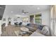 Bright living room with modern gray sofa, natural light from large windows, and an open floor plan at 15221 N Clubgate Dr # 2094, Scottsdale, AZ 85254