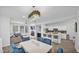 Open concept living space featuring modern chandelier, fireplace and kitchen with island at 15221 N Clubgate Dr # 2094, Scottsdale, AZ 85254