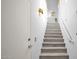 Bright stairway with modern sconces, light wood stairs, and white walls at 15221 N Clubgate Dr # 2094, Scottsdale, AZ 85254