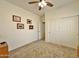 This bedroom has carpet flooring, a ceiling fan, and neutral walls at 15950 S Hilo Cir, Arizona City, AZ 85123