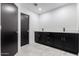 Bathroom featuring a double vanity with black cabinets, white countertops and modern fixtures at 16422 S 45Th Pl, Phoenix, AZ 85048