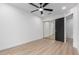 Bright bedroom with a ceiling fan, wood-look floors, and mirrored closet at 16422 S 45Th Pl, Phoenix, AZ 85048