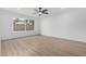 Bright, open bedroom with light wood-look flooring and a large window at 16422 S 45Th Pl, Phoenix, AZ 85048