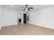 Bright bedroom featuring a ceiling fan, light wood flooring, and ensuite bathroom at 16422 S 45Th Pl, Phoenix, AZ 85048