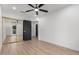 Bright bedroom features a ceiling fan, wood-look floors, and mirrored closet at 16422 S 45Th Pl, Phoenix, AZ 85048