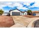 Charming home showcasing modern exterior with gray garage and neutral paint with spacious driveway and desert landscaping at 16422 S 45Th Pl, Phoenix, AZ 85048