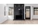 Modern living space with a black marble fireplace and light wood-look flooring at 16422 S 45Th Pl, Phoenix, AZ 85048