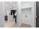 View of hallway leading into kitchen, featuring dark cabinets and light floors at 16422 S 45Th Pl, Phoenix, AZ 85048