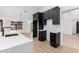 Kitchen featuring custom black cabinets and a large island with quartz countertops at 16422 S 45Th Pl, Phoenix, AZ 85048