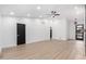 Bright, open living space showcasing modern floors, recessed lighting, and sleek black doors at 16422 S 45Th Pl, Phoenix, AZ 85048
