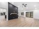 Spacious living room featuring modern lighting, sleek floors and black accent wall at 16422 S 45Th Pl, Phoenix, AZ 85048