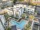 Aerial view of modern townhomes surrounding a community pool and patio area with palm trees at 1717 E Morten Ave # 2, Phoenix, AZ 85020