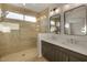 Beautiful bathroom featuring a glass shower enclosure, dual sinks, and modern fixtures at 1717 E Morten Ave # 2, Phoenix, AZ 85020