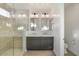 Modern bathroom featuring double vanity, framed mirrors, and luxurious glass enclosed shower at 1717 E Morten Ave # 2, Phoenix, AZ 85020
