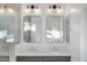 Elegant bathroom with dual sinks, modern lighting, and stylish framed mirrors at 1717 E Morten Ave # 2, Phoenix, AZ 85020