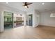 Bright bedroom featuring tile floors, ceiling fan, and two large sliding glass doors to balcony at 1717 E Morten Ave # 2, Phoenix, AZ 85020