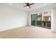 Bright bedroom featuring tile floors, ceiling fan, and large sliding glass door to balcony at 1717 E Morten Ave # 2, Phoenix, AZ 85020