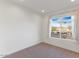 Bedroom featuring neutral walls, neutral carpeting, and a bright window at 1717 E Morten Ave # 2, Phoenix, AZ 85020