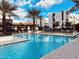 Community pool with surrounding modern buildings, palm trees, and mountain backdrop on a sunny day at 1717 E Morten Ave # 2, Phoenix, AZ 85020