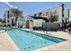 Community pool with surrounding modern buildings, covered seating, and a well-maintained deck on a sunny day at 1717 E Morten Ave # 2, Phoenix, AZ 85020