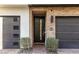Inviting entryway with brick accents, black door, and lush landscaping at 1717 E Morten Ave # 2, Phoenix, AZ 85020