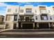 Modern three-story townhome featuring a balcony and attached two-car garage at 1717 E Morten Ave # 2, Phoenix, AZ 85020