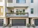 A townhouse featuring a private garage and balcony with lush planter boxes at 1717 E Morten Ave # 2, Phoenix, AZ 85020